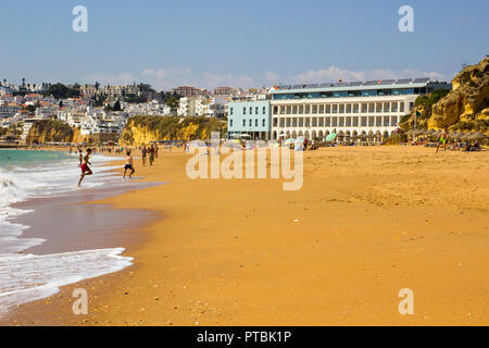 28 September 2018 A view along Praia do Inatel toward the Old Town Albuferia on the Algarve with sun beds and sand Stock Photo