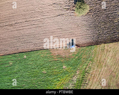 Aerial view of tractor plowing the field Stock Photo