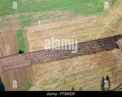 Aerial view of tractor plowing the field Stock Photo