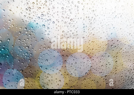 Waterdrops on a glass surface windows with bokeh background Stock Photo