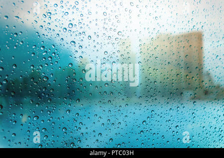 Waterdrops on a glass surface windows with cityscape background Stock Photo