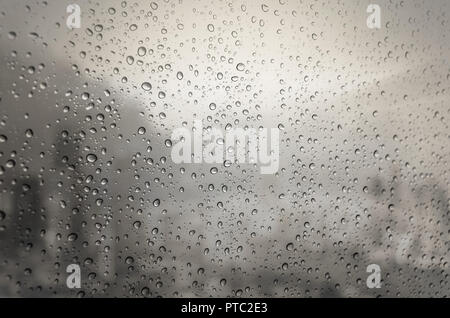 Waterdrops on a glass surface windows with cityscape background Stock Photo