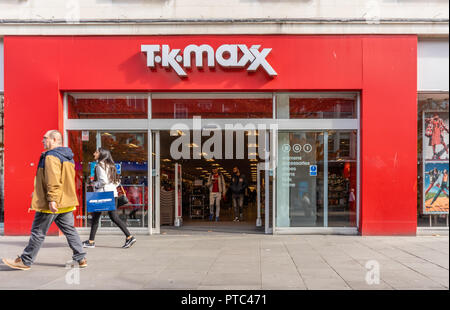 A woman walking past a TK MAXX store front in Southern England, UK, Europe Stock Photo