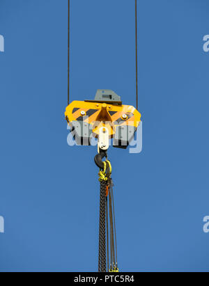 SEATTLE, WASHINGTON STATE, USA - JUNE 2018: Close up view of the pulley and hook of a tower cranes in Seattle city centre against a blue sky. Stock Photo