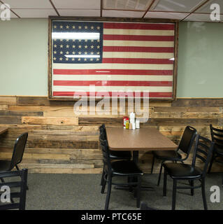 American Flag framed and hanging on the wall at a small town country restaurant. Stock Photo