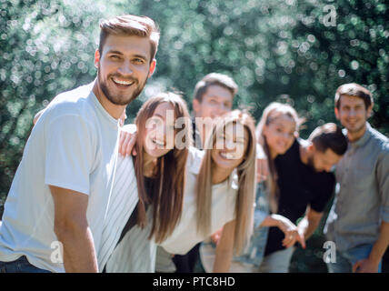 happy group of friends is spending time in the city Park Stock Photo