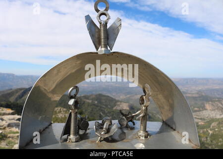 Alternative Nativity scene made from stainless steel nuts and bolts set on top of a mountain in Spain with views of the Serres de Cardo el Boix Stock Photo