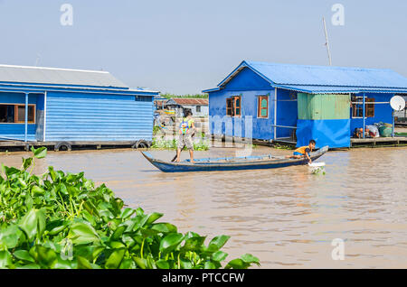 Siem Reap, Cambodia - April 11, 2018: One of the floating villages around Siem Reap on the Tonle Sap Lake covered with  invasive water hyacinth with i Stock Photo