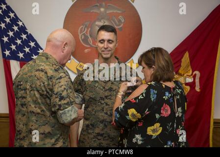 U.S. Marines, family and friends gather for Maj. Gen. Robert F. Castellvi's promotion ceremony on Camp Lejeune, N.C., 11 July, 2017. Castellvi was promoted from Brigadier General to Major General by Maj. Gen. Walter L. Miller. Stock Photo