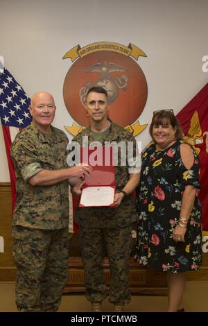 U.S. Marines, family and friends gather for Maj. Gen. Robert F. Castellvi's promotion ceremony on Camp Lejeune, N.C., 11 July, 2017. Castellvi was promoted from Brigadier General to Major General by Maj. Gen. Walter L. Miller. Stock Photo