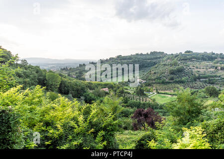 Umbria countryside in Chiusi, Italy near Tuscany with rolling green hills, houses and farms during sunset landscape idyllic picturesque olive groves Stock Photo
