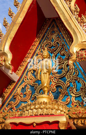 Close-up of a Buddha statue and ornate and intricate facade of the Buddhist Wat Chanthaburi (Chanthaboury) Temple in Vientiane, Laos, on a sunny day. Stock Photo