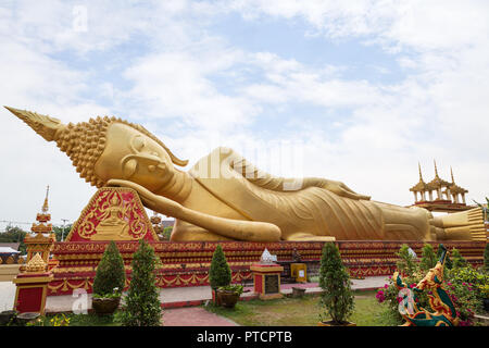 Large gilded Reclining Buddha statue at the Wat That Luang Tai Temple in Vientiane, Laos. Stock Photo