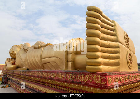 Large gilded Reclining Buddha statue at the Wat That Luang Tai Temple in Vientiane, Laos. Stock Photo