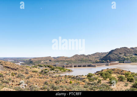 The Vanderkloof Dam in the Orange River (Gariep River) as seen from Vanderkloof town. The river below the dam wall and the moon are visible Stock Photo