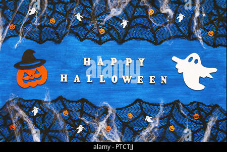 Halloween background. Happy Halloween letters and Halloween decorations on the dark blue wooden background, Happy Halloween concept Stock Photo