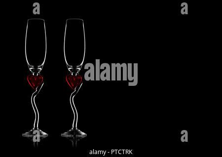 Two silhouettes of glasses for champagne on a black isolated background Stock Photo