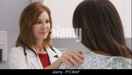 Lovely middle aged woman consoling young patient about dealing with trauma