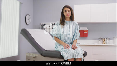 Close up of lovely latina woman seated on medical chair in hospital clinic Stock Photo