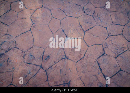 Vintage nature cobblestone and pebbles pavement in disorganized arrangement pattern background. Paving blocks made of nature asymmetrical stone backgr Stock Photo