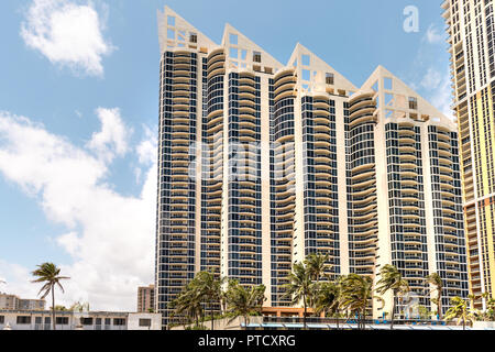 Sunny Isles Beach, USA - May 4, 2018: Pinnacle Condominium residences apartment building, skyscraper, condominium complex on shore, beachfront, coast, Stock Photo