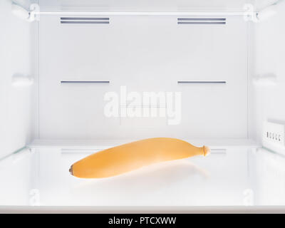 Single banana in the empty fridge. Stock Photo