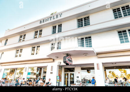 South Beach, USA - May 5, 2018: Bentley Hotel in Miami, Florida in Art Deco district with people sitting, eating, dining at TGI Friday's outside, outd Stock Photo