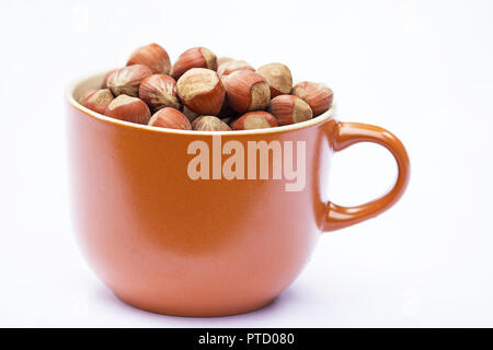 Hazelnuts in a soup bowl, on white background Stock Photo