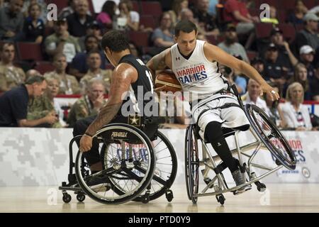 Navy veteran Chief Petty Officer Javier Rodriguez, right, collides with Army veteran Spc. Jarred Vaina during the 2017 Dept. of Defense Warrior Games at the United Center in Chicago July 7, 2017. Stock Photo