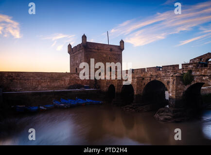 ESSAOUIRA, MOROCCO - CIRCA MAY 2018:  Sunset over the port of Essaouria and the famous Castelo Real of Mogador. Stock Photo