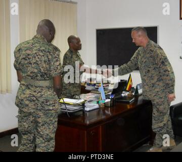 Maj. Gen. Wilson Mbadi, the Deputy Chief of Uganda People’s Defense Force (middle) greets Combined Joint Task Force-Horn of Africa commander U.S. Marine Corps Brig. Gen. David Furness (right) for an office call during a recent visit to an historic UPDF engineering course graduation at the Uganda Rapid Deployment Capability Center, based in Jinja, Uganda. The two military leaders, along with Uganda Rapid Deployment Capability Center commandant Maj. Gen. James Nnkibus Lakara (far left) discussed shared interests, including partnership opportunities for future courses. In the latest iteration of  Stock Photo