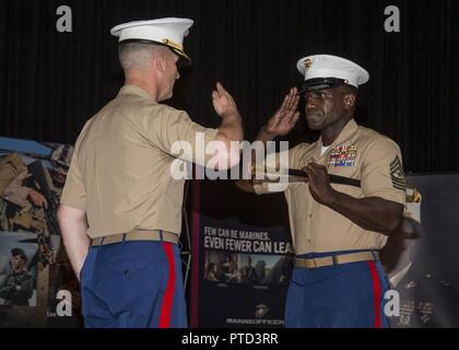 Sergeant Major Anthony N. Page, right, salutes Col Jeffery C. Smitherman, commanding officer of 6th Marine Corps District (6MCD), during the 6MCD Relief and Appointment Ceremony at the base theater aboard Marine Corps Recruit Depot (MCRD) Parris Island, South Carolina, July 7, 2017. Sergeant Major Anthony N. Page was relieved by SgtMaj Cortez L. Brown after serving as the sergeant major of 6MCD for more than 3 years. Stock Photo