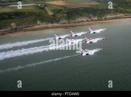 The U.S. Air Force Thunderbirds fly off coast of Normandy Beach, Normandy, France, July 11, 2017. The Thunderbirds were participating flew over several historic sites during a practice fly by of Paris, France for Bastille Day. Stock Photo