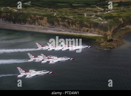 The U.S. Air Force Thunderbirds fly off coast of Pointe du Hoc, Normandy, France, July 11, 2017. During World War II, it was the highest point between Utah Beach to the west and Omaha Beach to the east. The Thunderbirds were participating flew over several historic sites during a practice fly by of Paris, France for Bastille Day. Stock Photo