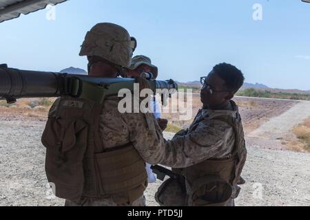 U.S. Marine Corps Sergeant Tevin Thomas (right) and Corporal Sean Dopler, Low Altitude Air Defense (LAAD) gunners with 3rd LAAD Battalion, Marine Air Control Group 38 (MACG-38), 3rd Marine Aircraft Wing (3D MAW) inspect a FIM-92 Stinger during a live fire exercise at Yuma Proving Grounds, Yuma, Ariz., July 8, 2017. 3rd LAAD Battalion conducted the exercise in order to maintain proficiency and accuracy with the FIM-92 Stinger. Stock Photo