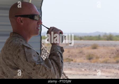 U.S. Marine Corps Gunnery Sgt. Justin Poole, a training chief with 3rd Low Altitude Air Defense (LAAD) Battalion, Marine Air Control Group 38 (MACG-38), 3rd Marine Aircraft Wing (3D MAW) talks on the radio during a stinger live fire exercise at Yuma Proving Grounds, Yuma, Ariz., July 8, 2017. 3rd LAAD Battalion conducted the exercise in order to maintain proficiency and accuracy with the FIM-92 Stinger. Stock Photo