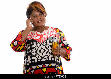 Thoughtful happy fat black African woman smiling and talking on  Stock Photo