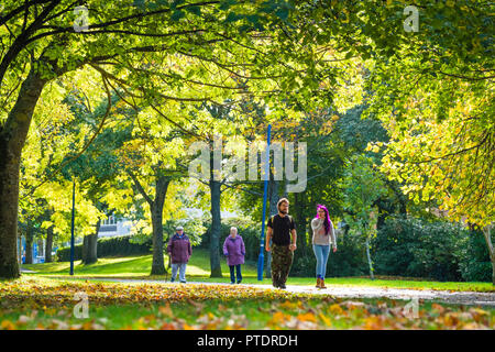 Aberystwyth Wales UK, Tuesday 09 October 2018.  UK Weather: People walking along the tree lined Park Avenue in Aberystwyth on a gloriously sunny October morning. With over 20 different kinds of deciduous trees, the park is a riot of colour in the autumn as the leaves begin to fall. Photo  credit: Keith Morris/ Alamy Live News Stock Photo