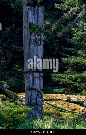 Totem poles at Gwaii Haanas National Park at Haida Gwaii, Canada Stock Photo