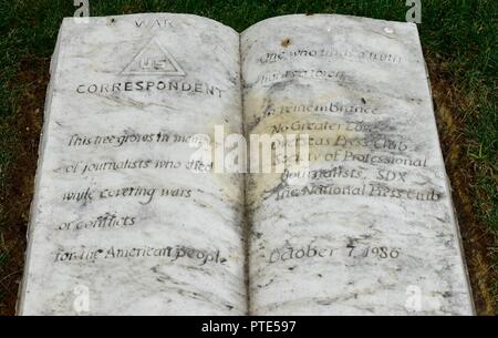 The War Correspondents Memorial stone at Arlington National Cemetery on July 11.    Inscription on the stone reads:    'WAR CORRESPONDENT    This tree grows in memory  of journalists who died  while covering wars  or conflicts  for the American people.    One who finds a truth lights a torch.  In remembrance  No Greater Love  Overseas Press Club  Society of Professional  Journalists, SDX  The National Press Club    October 7, 1986' Stock Photo