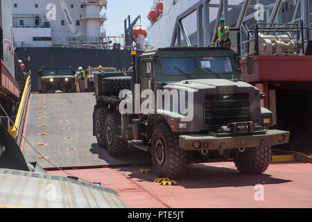 A U.S. Marine Corps AMK26 Recovery Truck drives off a ramp during exercise Pacific Horizon 2017 aboard the USNS John Glenn, July 7, 2017. Pacific Horizon 2017 is a Maritime Prepositioning Force (MPF) exercise designed to train I Marine Expeditionary Force (MEF) and components of Naval Beach Group 1 (NBG-1) Marines and Sailors on arrival and assembly operation as well as follow-on Marine Air Ground Task Force actions to ensure that the right equipment, supplies and tools get to the right people to be employed in a crisis response, humanitarian assistance or amassing combat power ashore from sea Stock Photo