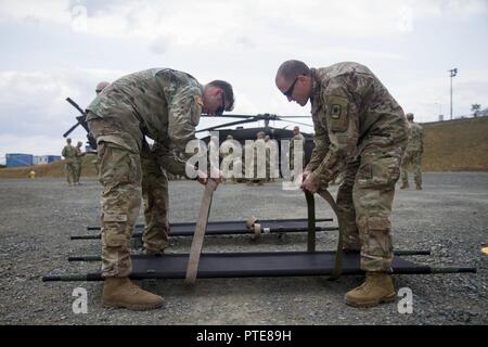 Sgt. Noah Hughes (left), medic with 421st Multifunctional Medical Battalion, 30th Medical Brigade, teaches Maj. David Farrington, soldier with 361st Civil Affairs Brigade, how to secure litter straps of a during training at Novo Selo Training Area, Bulgaria during Saber Guardian 17, July 17 Stock Photo