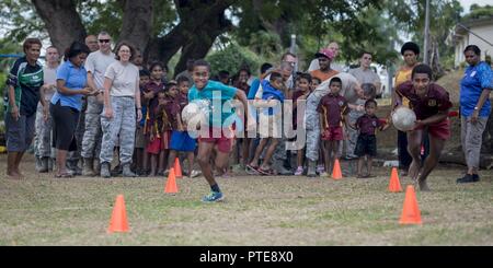 Two Fijian boys race against time during an obstacle course competition where they paired up with a U.S. service member on each team and fought the clock to get the whole team through the course before time ran out during a sports day community engagement activity at the Lautoka School for Special Education in Lautoka, Fiji, July 14, 2017. The service members are in Lautoka as part of Pacific Angel 2017 where they’re working with the Fijian government to provide humanitarian assistance and subject matter expert exchanges July 11 to 24. Stock Photo