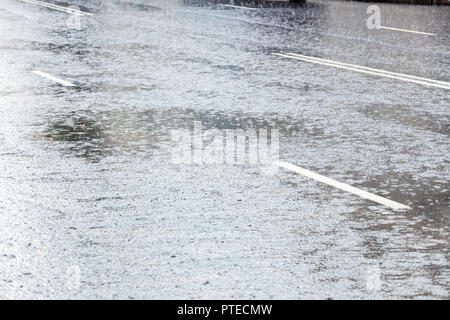 flooded city asphalt road during heavy rain Stock Photo