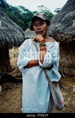 Santa Marta, Magdalena / Colombia - MARCH 10 2016 : tribal kogi man in front of ceremonial buildings in the middle of the cloudforest Stock Photo