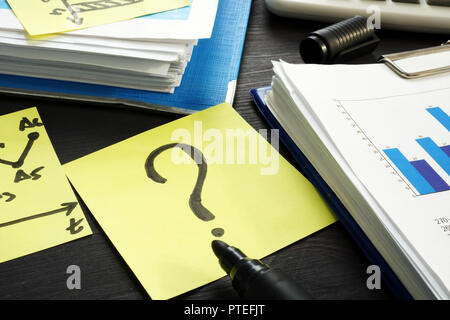 Question mark and financial report. Problems with business. Stock Photo