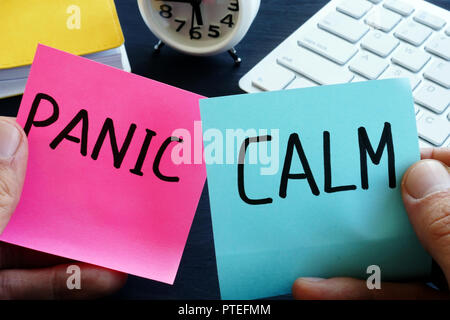 Words panic and calm on pieces of paper. Problem solving. Stock Photo