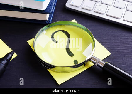 Question mark on a piece of paper. Problem solving. Stock Photo