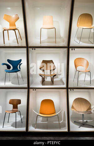 Copenhagen. Denmark. Danish Museum of Art & Design. Display of iconic Danish chairs, centre, GJ Bow Chair, 1963, designed by Grete Jalk (1920-2006). Stock Photo