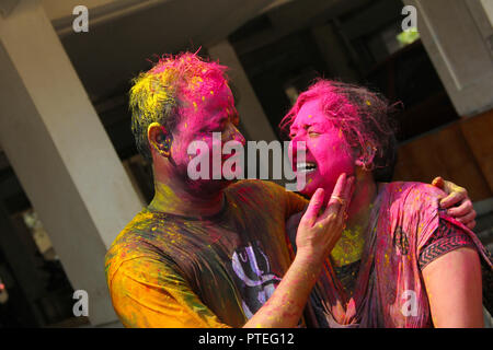 Young India couple enjoying Holi and applying dry color to each other, Pune, India Stock Photo
